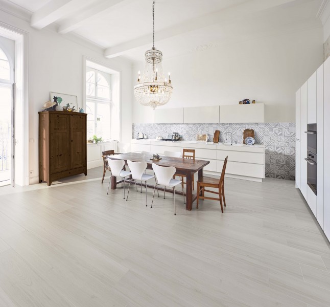 Modern kitchen with dining table in a refurbished old building